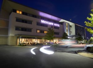 Front exterior shot of Mercure Sheffield Parkway Hotel at night with car headlights streaking across