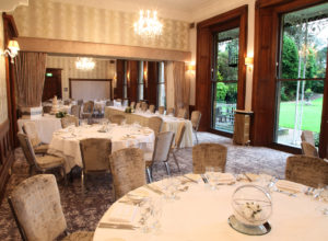 Tables set for large dinner in the William Morris Suite at Mercure Burton Upon Trent Newton Park Hotel
