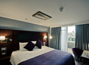 Double bed and view of Edinburgh Castle from bedroom at Mercure Edinburgh City Princes Street Hotel